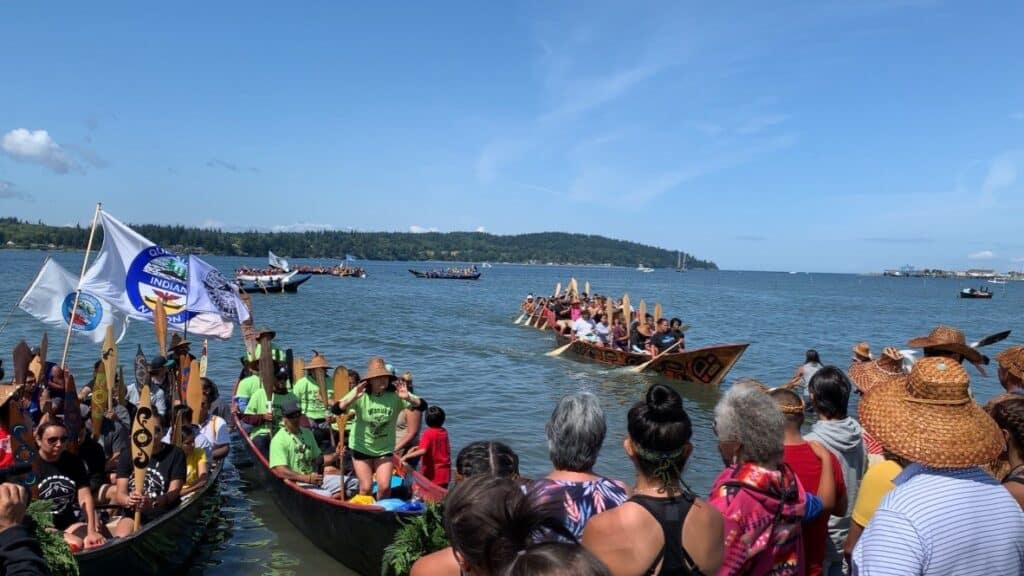 Tribal canoes coming ashore Lummi Island