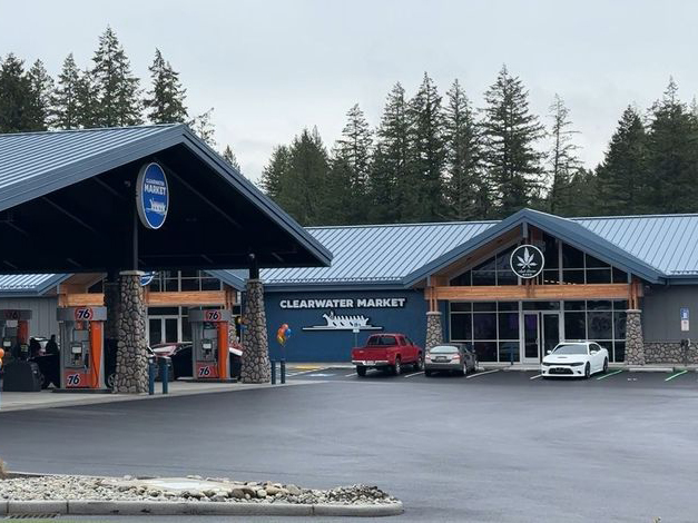 A dark blue gas station and convenience store labeled "Clearwater Market." 
